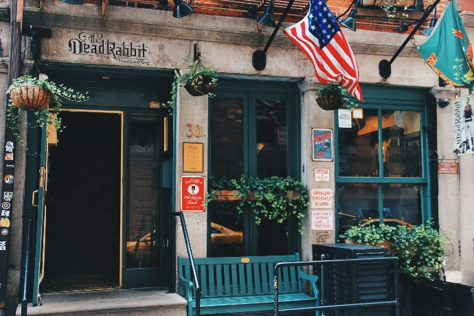 green wooden bench beside green wooden framed glass window